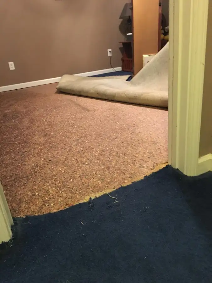 Carpet pad removal revealing water damage during Water Mitigation Services in Yazoo City